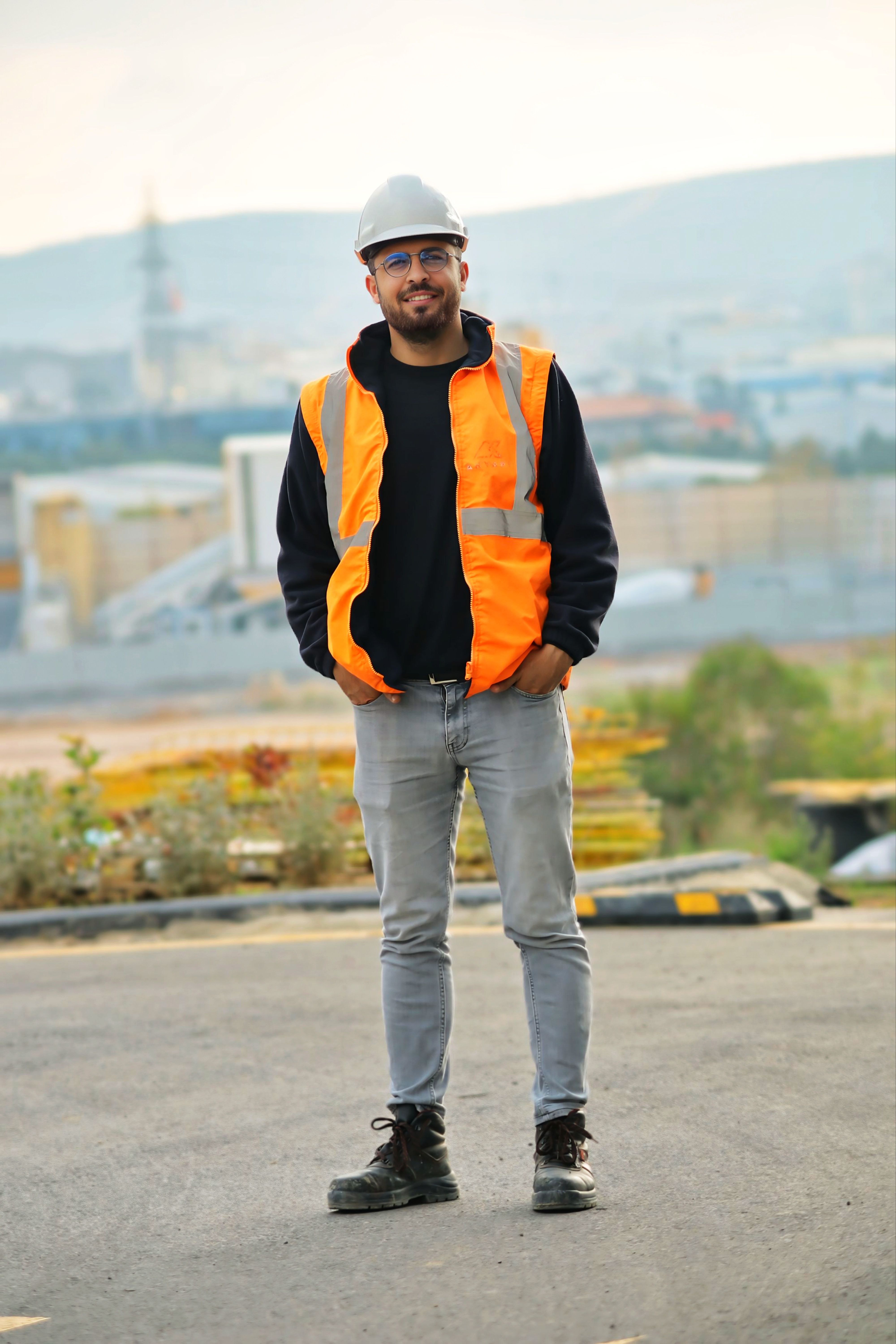 Worker wearing high-visibility workwear at an industrial site