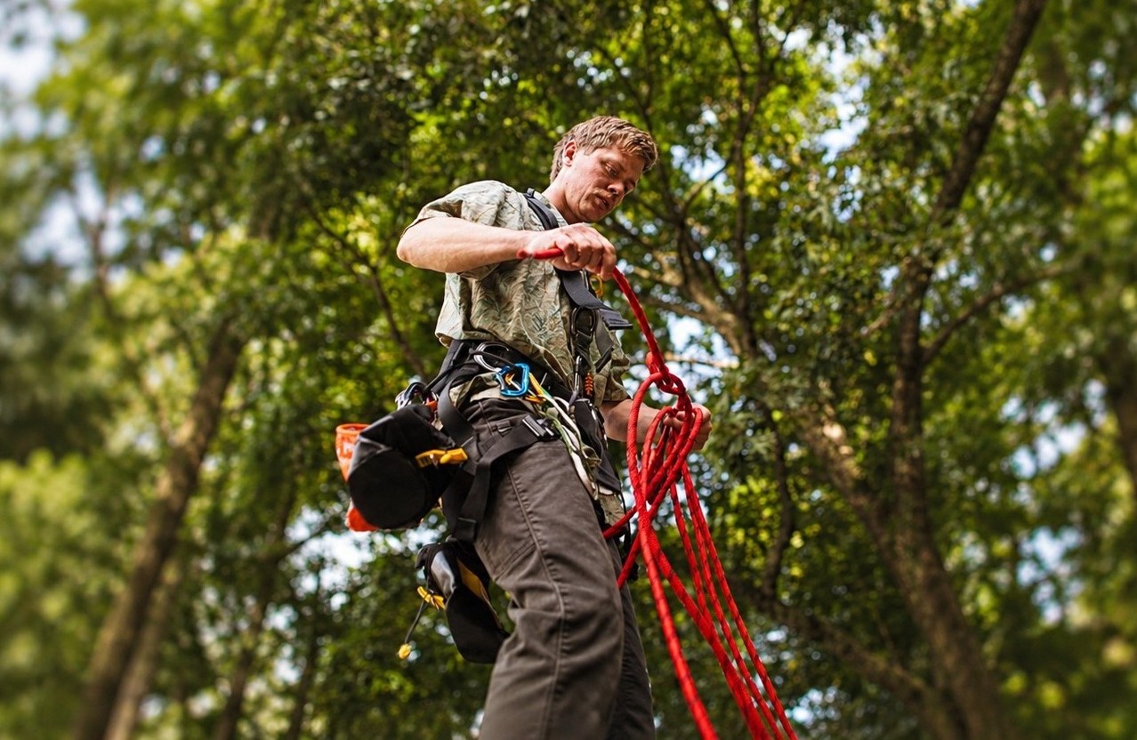 Worker using rope and fall protection equipment